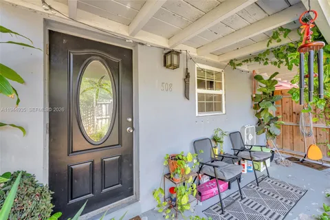 a front view of a house with outdoor seating and wooden floor