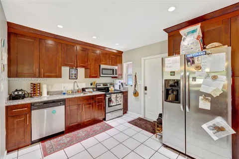 a kitchen with stainless steel appliances granite countertop a refrigerator and a stove top oven