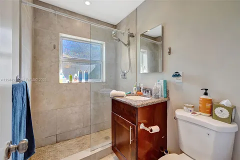 a bathroom with a sink toilet vanity and tub