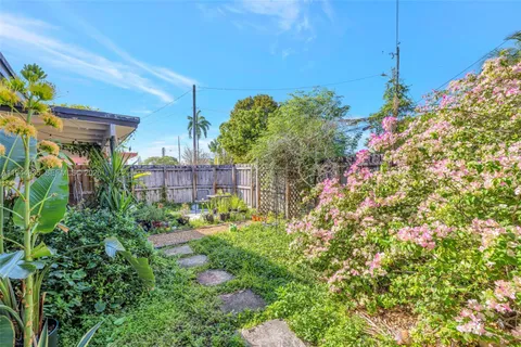 a view of a backyard with plants and a patio