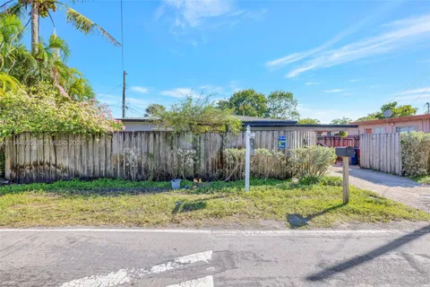 a view of a house with a yard and plants