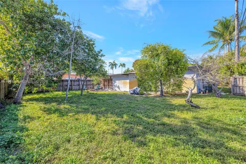 a view of a house with yard and sitting area