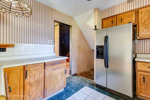 a kitchen with stainless steel appliances granite countertop a refrigerator and a sink