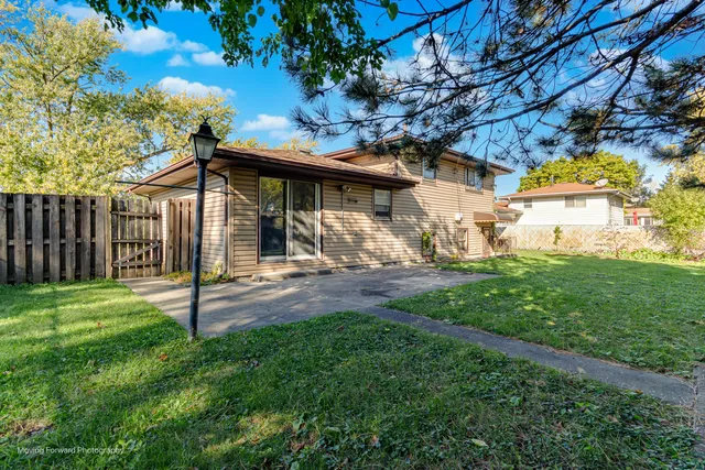 a view of a house with yard and a garden