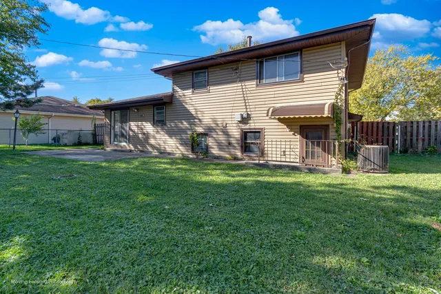 a front view of house with a garden