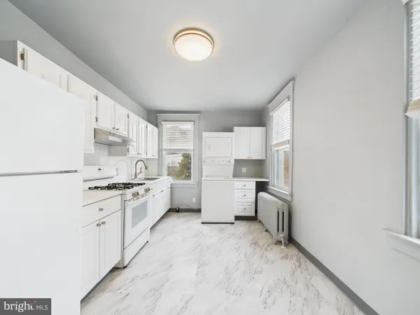 a kitchen with a stove a sink and a refrigerator
