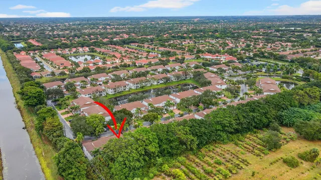 a view of a swimming pool with a lounge chair and palm trees