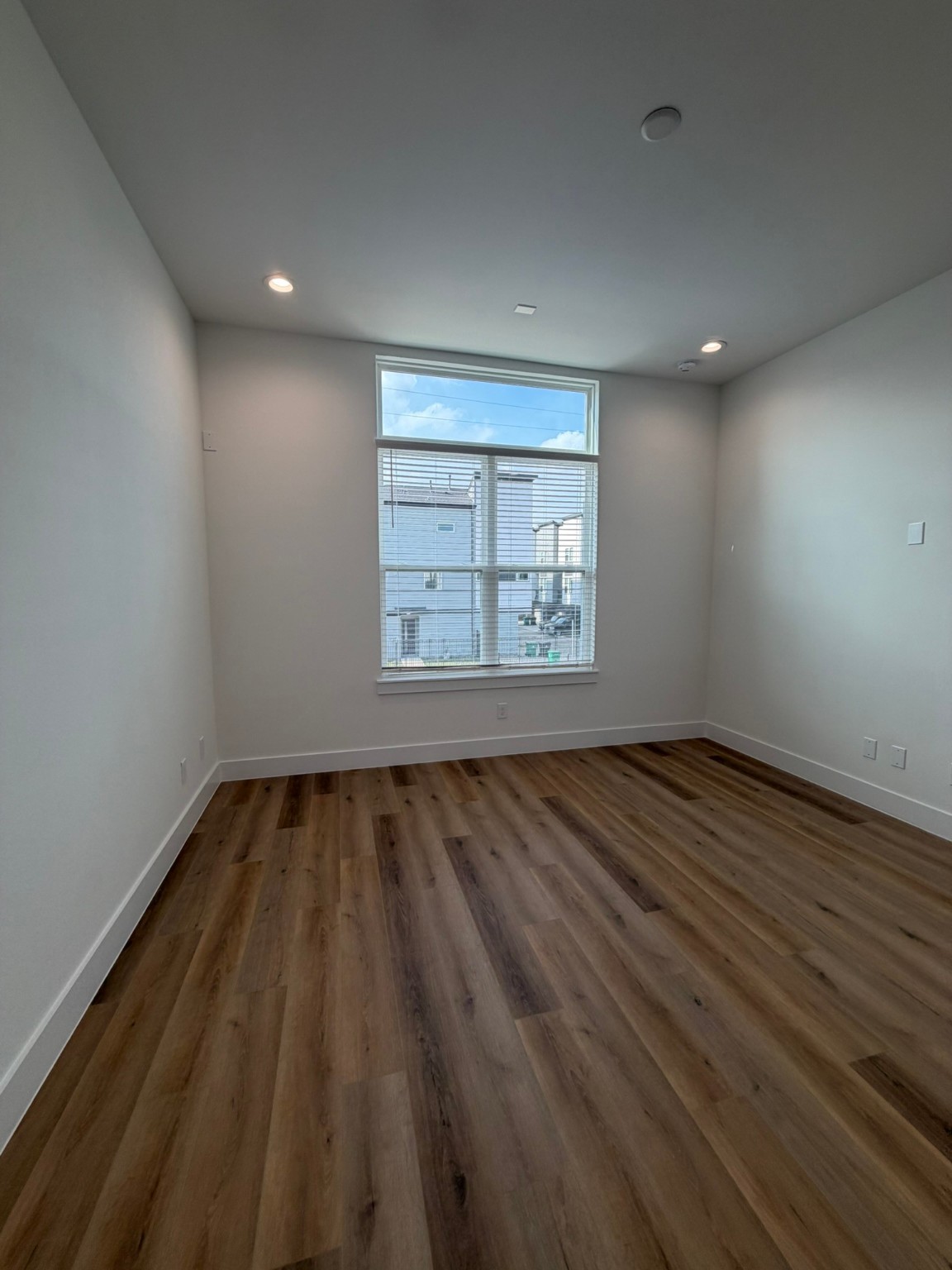 6733 Peerless Street Houston, TX 77021 - Photo 8 of 22 an empty room with wooden floor and windows