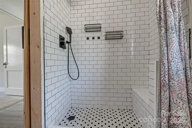 a view of a house with a big yard and large trees