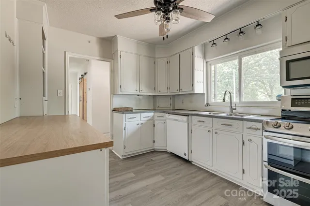 a kitchen with stainless steel appliances a refrigerator sink and cabinets