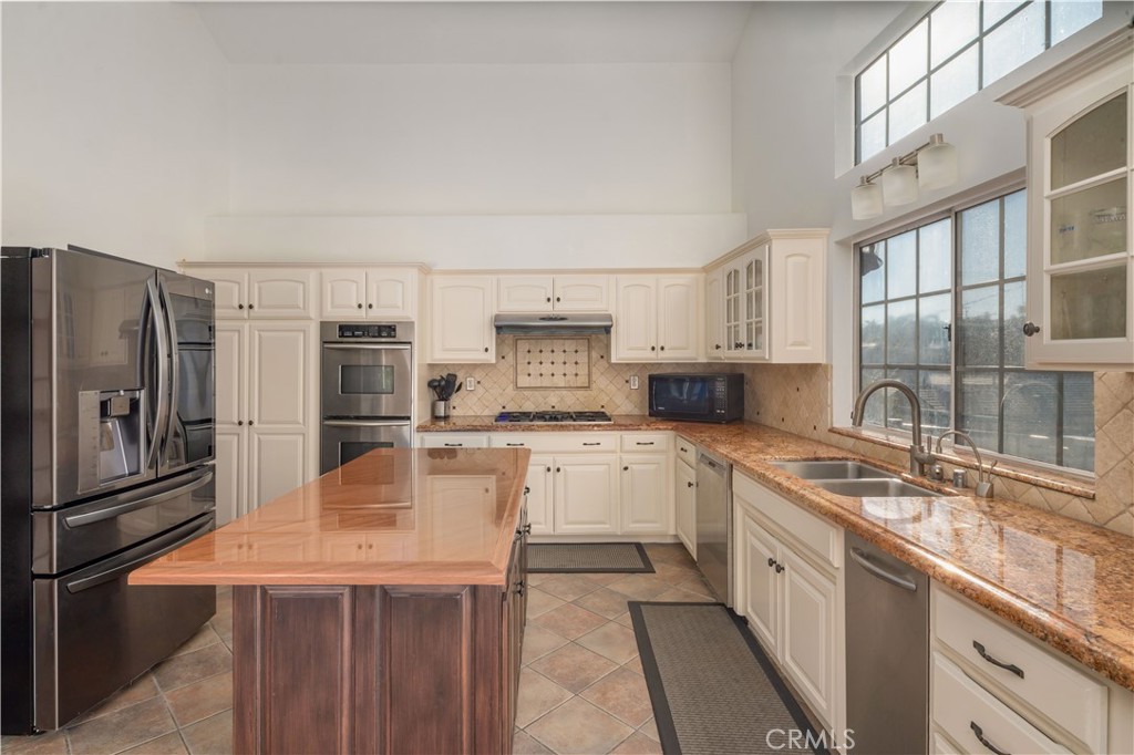 2201 Agnes Road Manhattan Beach, CA 90266 - Photo 11 of 36 a kitchen with stainless steel appliances granite countertop a sink stove and refrigerator