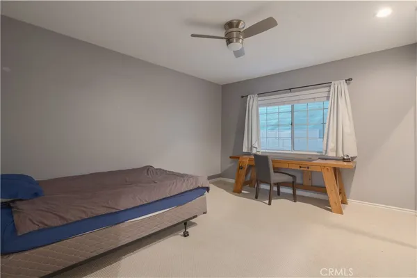 a bedroom with a bed and a table in it