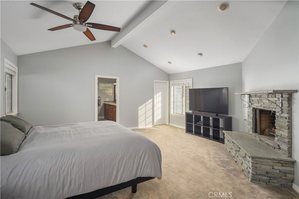 2201 Agnes Road Manhattan Beach, CA 90266 - Photo 22 of 36 a bedroom with a bed a flat screen tv and a fireplace