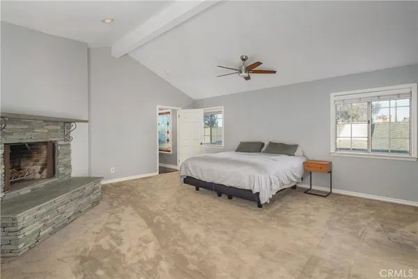 a spacious bedroom with a bed and a fireplace