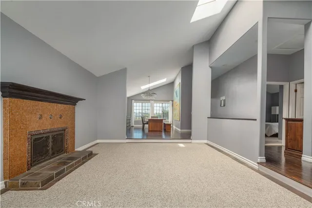 a living room with a fireplace and a large window