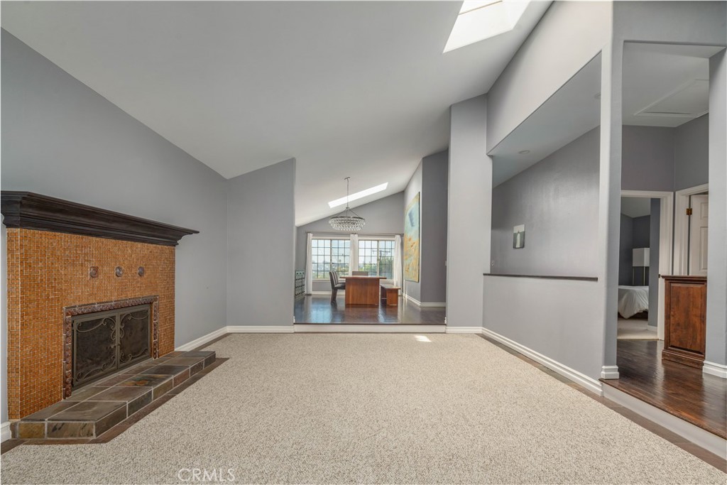 2201 Agnes Road Manhattan Beach, CA 90266 - Photo 5 of 36 a living room with a fireplace and a large window