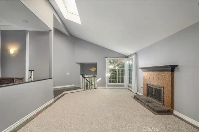 a large bedroom with a fireplace and a large window