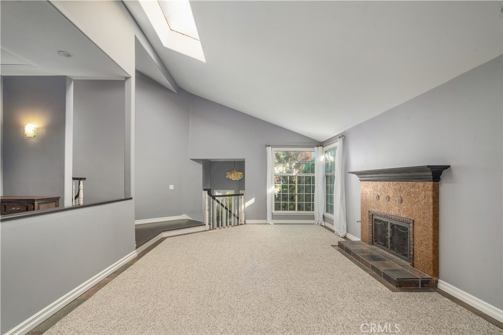 2201 Agnes Road Manhattan Beach, CA 90266 - Photo 6 of 36 a large bedroom with a fireplace and a large window