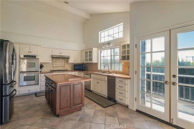 a kitchen with stainless steel appliances granite countertop a stove top oven and refrigerator