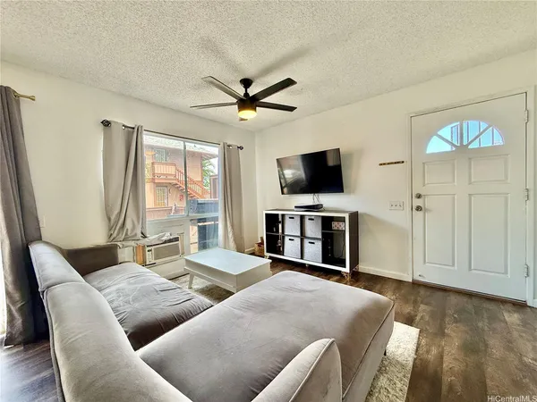 a living room with furniture a fireplace and a flat screen tv