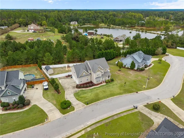 an aerial view of residential houses with outdoor space and pool