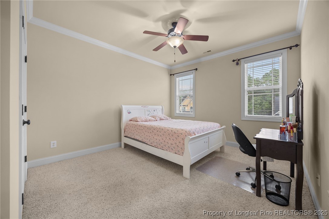 335 Lancelot Court Linden, NC 28356 - Photo 12 of 50 a bedroom with a bed a desk and chair with window