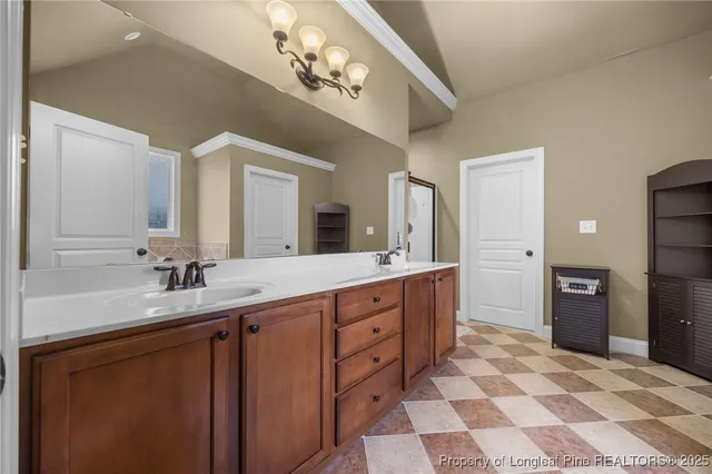 a spacious bathroom with a double vanity sink and a mirror