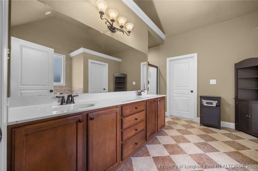 335 Lancelot Court Linden, NC 28356 - Photo 15 of 50 a spacious bathroom with a double vanity sink and a mirror