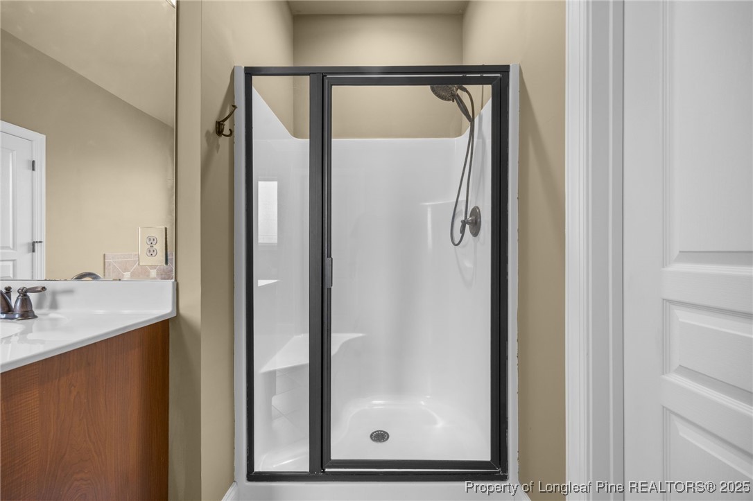 335 Lancelot Court Linden, NC 28356 - Photo 16 of 50 a bathroom with a mirror vanity and a shower