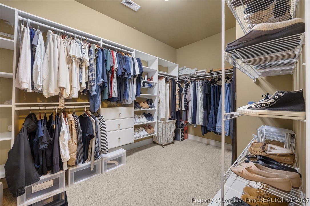335 Lancelot Court Linden, NC 28356 - Photo 19 of 50 a view of walk in closet with clothes and shoes