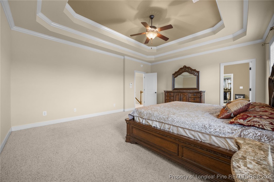 335 Lancelot Court Linden, NC 28356 - Photo 20 of 50 a bedroom with a large bed and a chandelier
