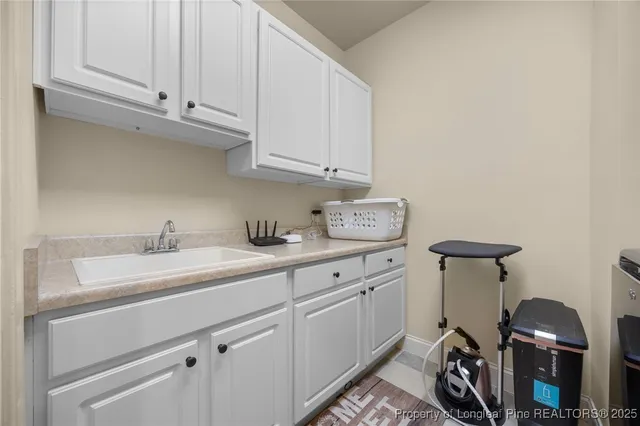 a kitchen with stainless steel appliances granite countertop a sink a stove and white cabinets