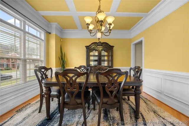 a view of a dining room with furniture and chandelier