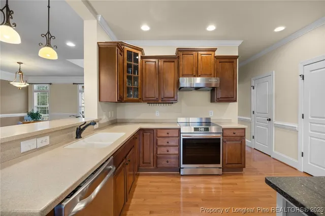 a kitchen with stainless steel appliances granite countertop a sink and stove top oven