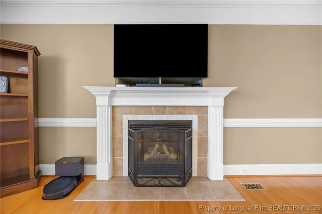 a living room with a fireplace and a flat screen tv