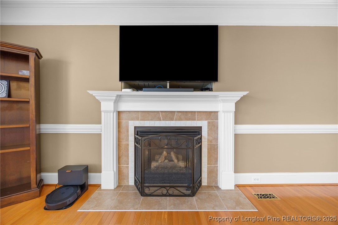 335 Lancelot Court Linden, NC 28356 - Photo 43 of 50 a living room with a fireplace and a flat screen tv