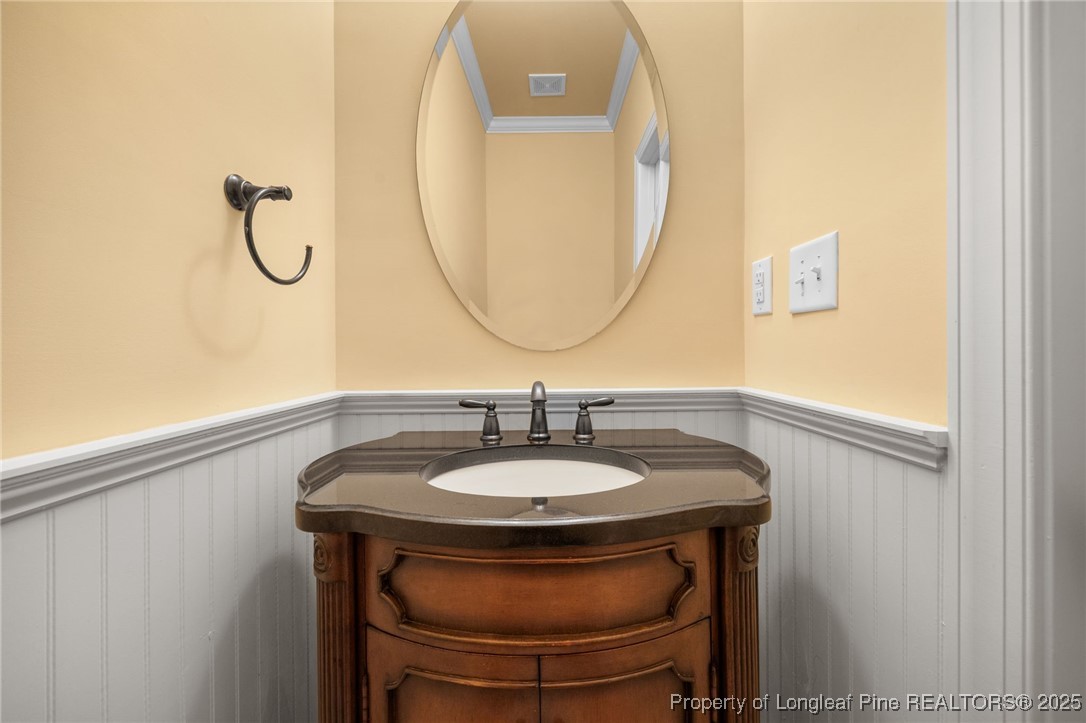 335 Lancelot Court Linden, NC 28356 - Photo 45 of 50 a bathroom with a sink and a mirror