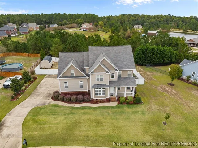 an aerial view of a house with a big yard