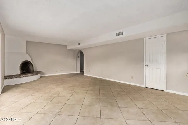 a view of a livingroom with furniture and floor to ceiling window