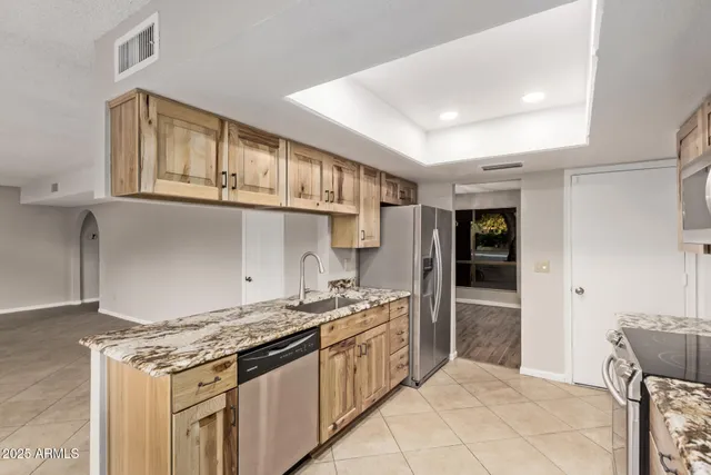 a large white kitchen with a large window