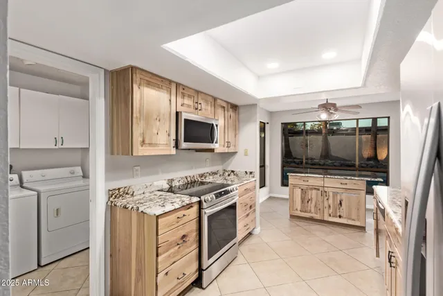 a kitchen with stainless steel appliances granite countertop a stove and a refrigerator