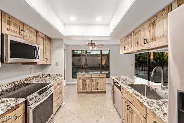 a kitchen with stainless steel appliances granite countertop a stove and a sink