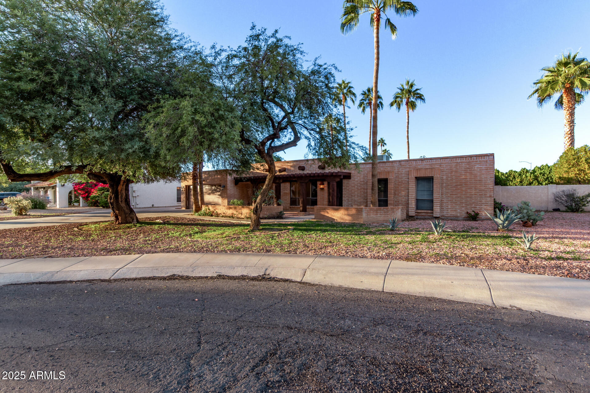 4912 East Ludlow Drive Scottsdale, AZ 85254 - Photo 2 of 36 a front view of a house with a yard and a garage