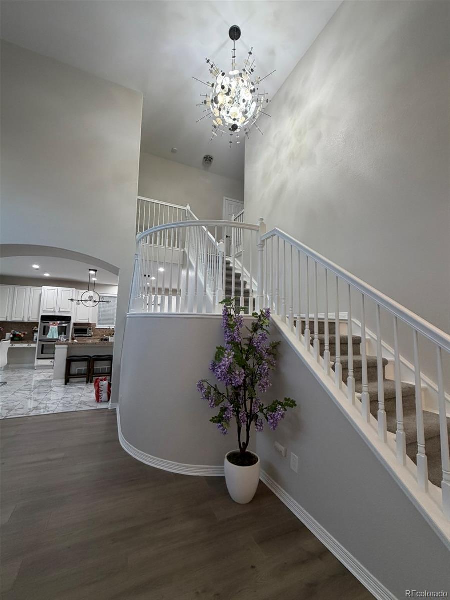 7242 South Rome Street Aurora, CO 80016 - Photo 24 of 33 a view of entryway and hall with wooden floor