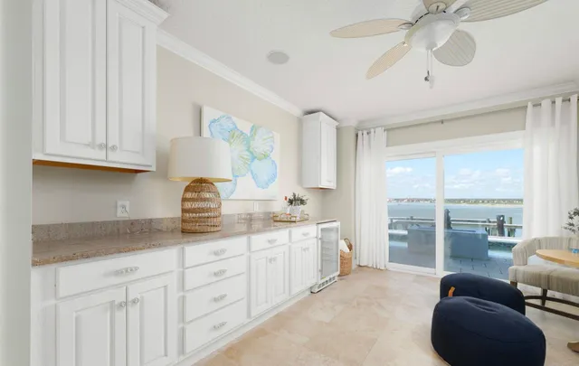 a spacious en suite bathroom with a granite countertop sink a mirror and a shower