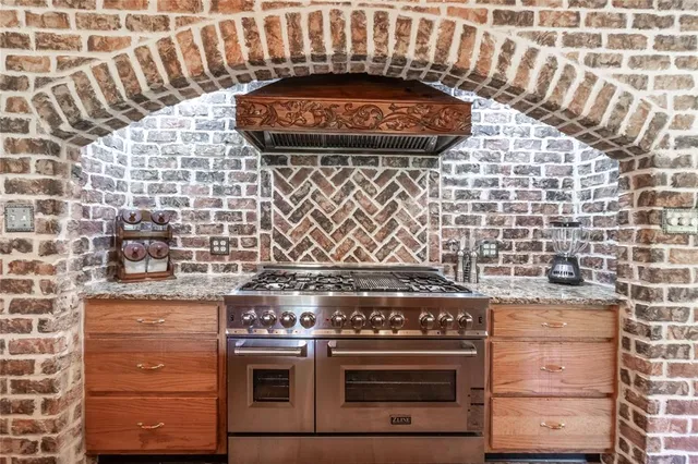 a stove top oven sitting inside of a kitchen
