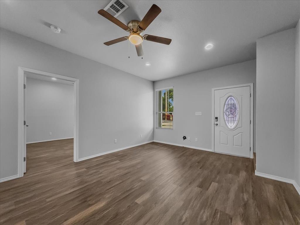 2 Bowling Lane Blue Ridge, TX 75424 - Photo 13 of 14 an empty room with wooden floor and a ceiling fan