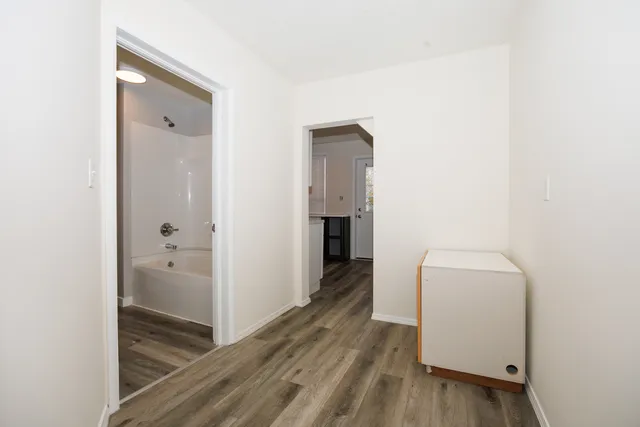 a view of hallway with wooden floor