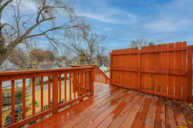 a balcony with wooden floor and fence