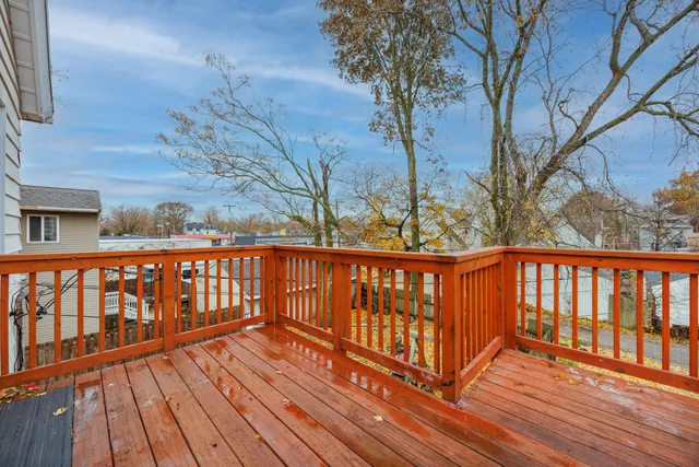 a balcony with wooden floor and fence